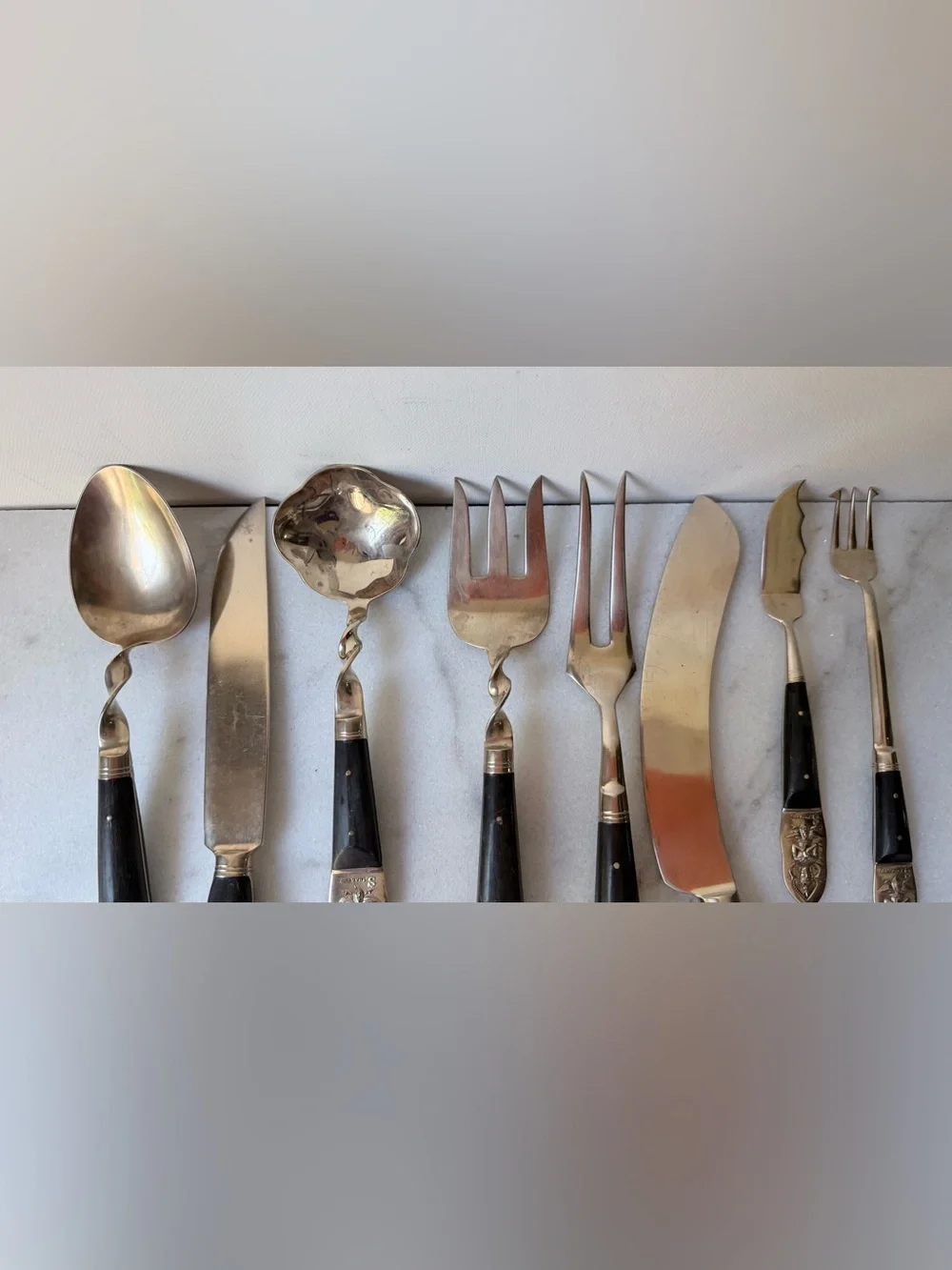 set consists of vintage Thai brass or bronze utensils with dark wooden handles.